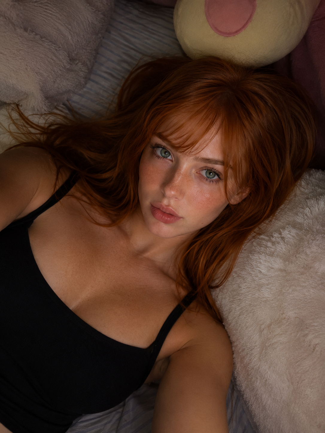 Scarlett lying down in a black top
